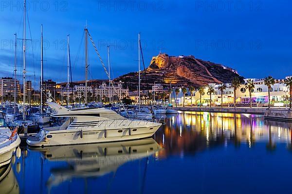 Port of Alicante at night Port dAlacant Marina with boats and view of Castillo Castle Holiday travel city in Alicante