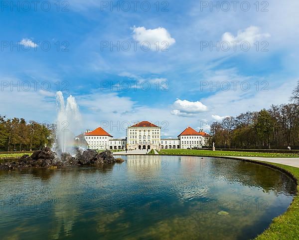 Fountain in Grand Parterre Baroque garden and the rear view of the Nymphenburg Palace. Munich