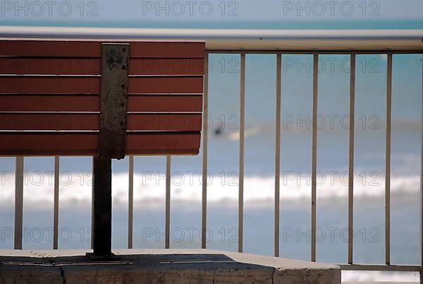 Close up pf a bench in front of the ocean in Ventura
