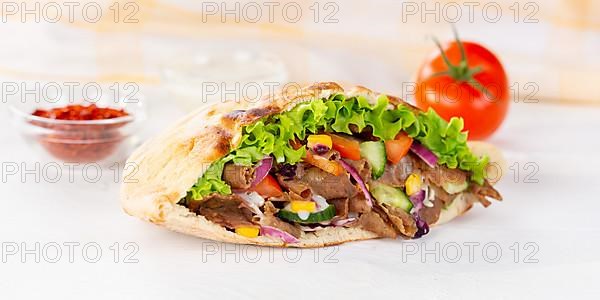 Doener Kebab Doner Kebap fast food in pita bread on wooden board Panorama in Stuttgart