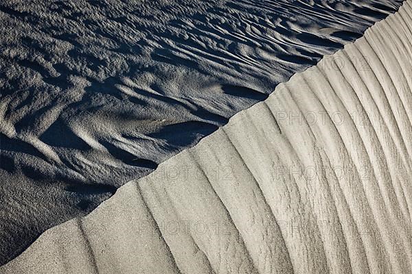 Shadow and light on Nubra Valley dunes sand close up on sunrise. Ladakh