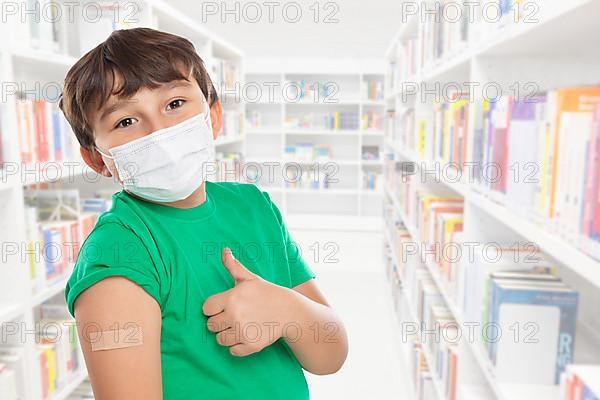 Child Boy With Plaster At Children Vaccination Mask Showing Thumbs Up In School Against Coronavirus Corona Virus copy space Copyspace in Stuttgart