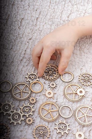 Hand holding gear wheels as the concept of mechanism