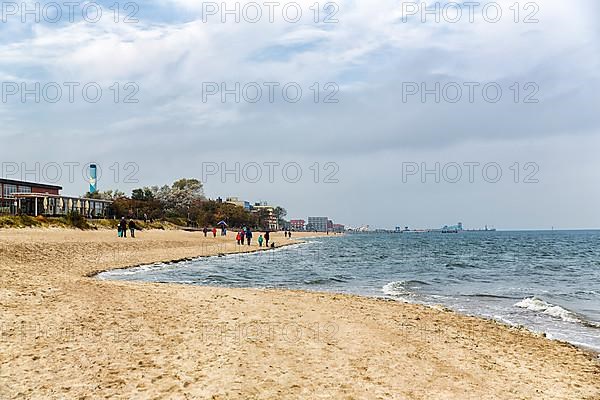 Strollers on the south beach in autumn