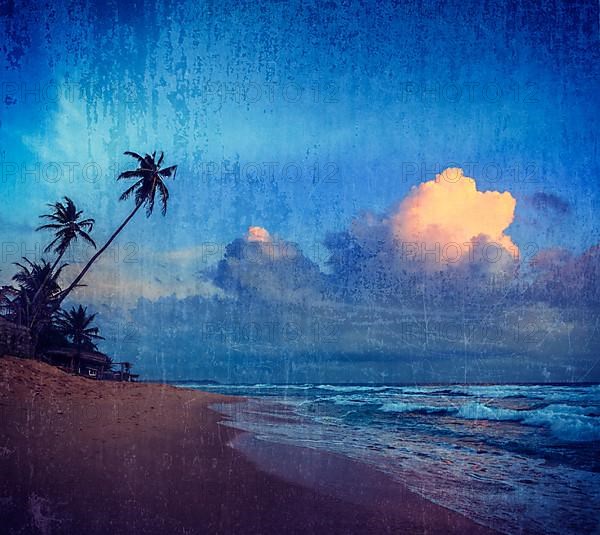 Vintage retro hipster style travel image of sunset on tropical beach. Sri Lanka with grunge texture overlaid