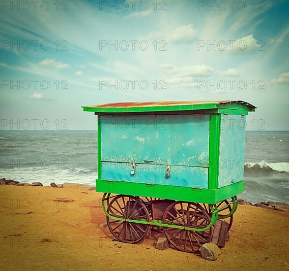 Vintage retro hipster style travel image of cart on beach. Tamil Nadu