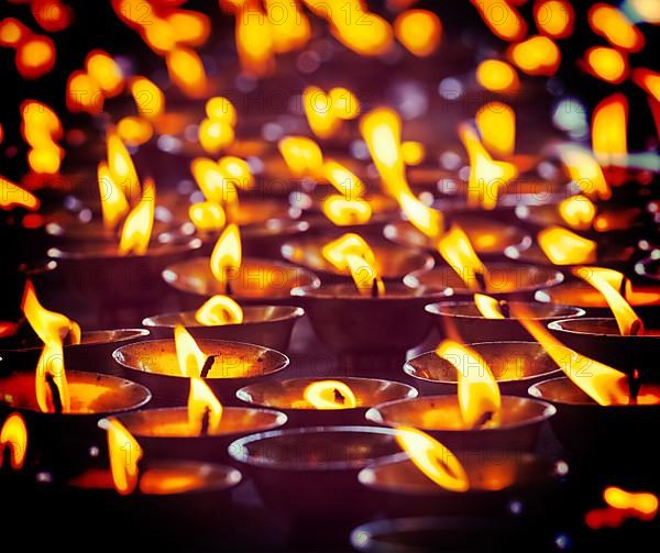 Vintage retro effect filtered hipster style travel image of burning candles in Buddhist temple. Tsuglagkhang complex