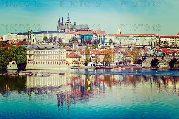 Vintage retro hipster style travel image of Charles bridge over Vltava river and Gradchany Prague Castle and St. Vitus Cathedral