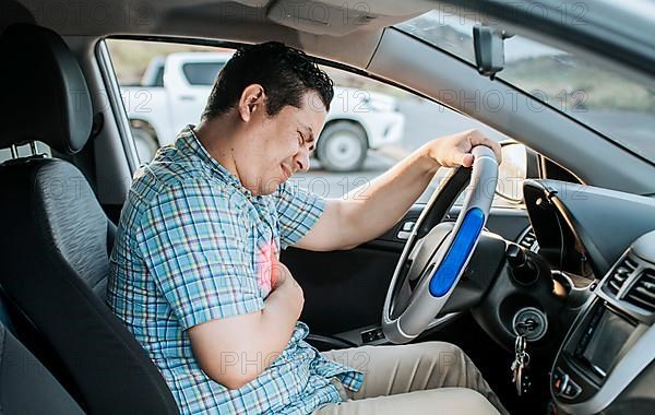 Person with heart attack while driving. Driver with chest pain. Driver's Heart Attack Concept