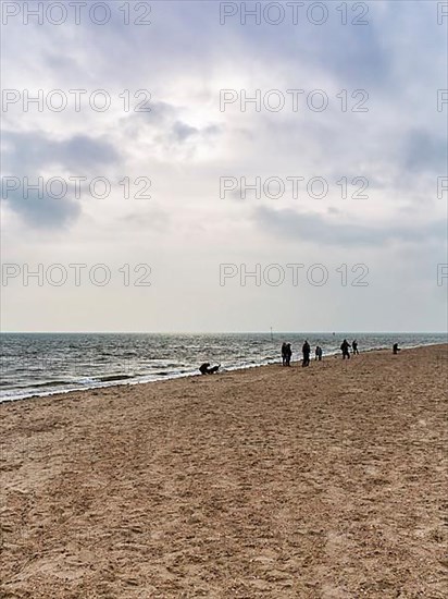 Strollers on the south beach in autumn