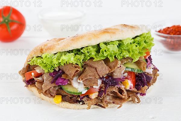 Doener Kebab Doner Kebap fast food meal in pita bread on wooden board in Stuttgart