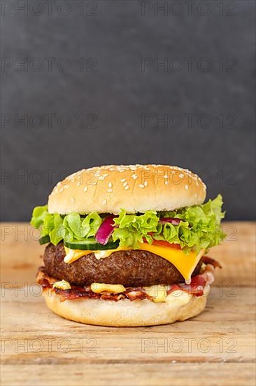 Hamburger cheeseburger fast food meal on wooden board in Stuttgart