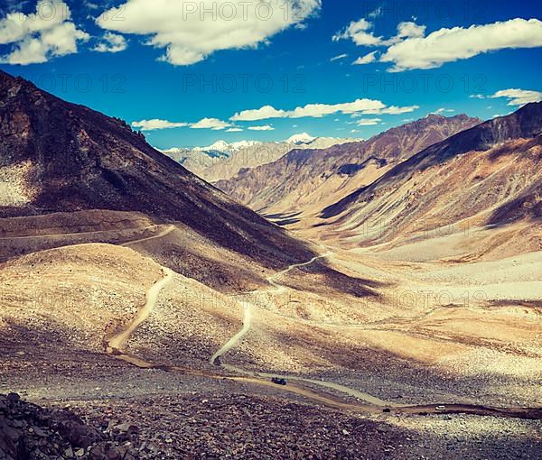 Vintage retro effect filtered hipster style travel image of Himalayan valley landscape with road near Kunzum La pass