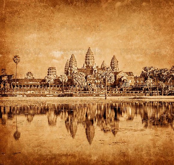 Vintage retro effect filtered hipster style weathered toned travel image of Cambodia landmark Angkor Wat with reflection in water