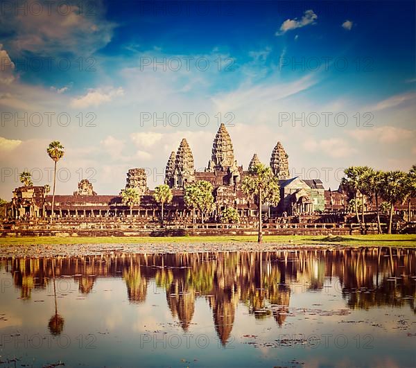 Vintage retro effect filtered hipster style travel image of Cambodia landmark Angkor Wat with reflection in water