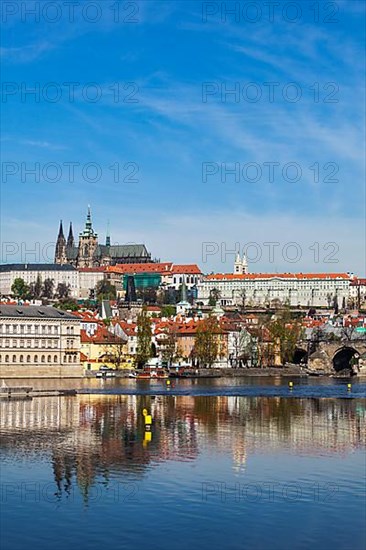 View of Charles bridge over Vltava river and Gradchany Prague Castle and St. Vitus Cathedral