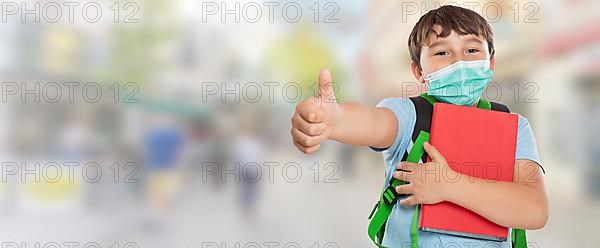 Young Pupil Child Boy With Mask Against Corona Virus Corona Virus In City Showing Thumbs Up With Text Free Space Copyspace in Stuttgart
