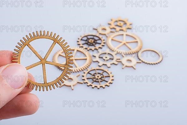 Hand holding gear wheels as the concept of mechanism