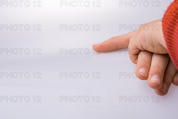 Child and grown up hands together on a white backgkround