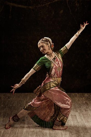 Vintage retro style image of young beautiful woman dancer exponent of Indian classical dance Bharatanatyam