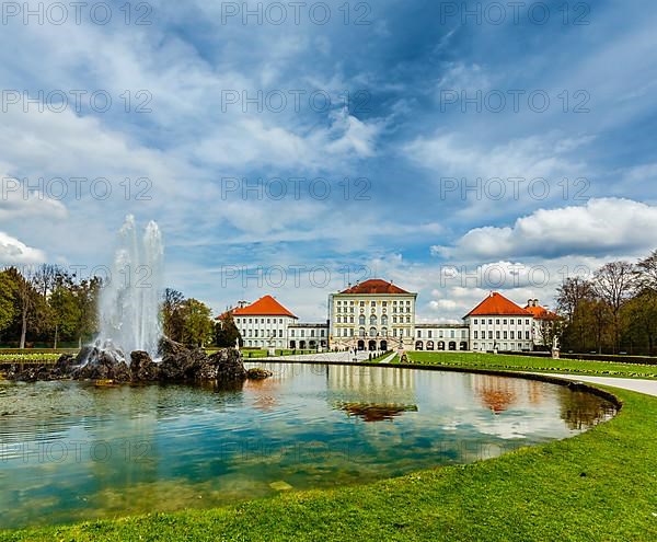 Fountain in Grand Parterre Baroque garden and the rear view of the Nymphenburg Palace. Munich