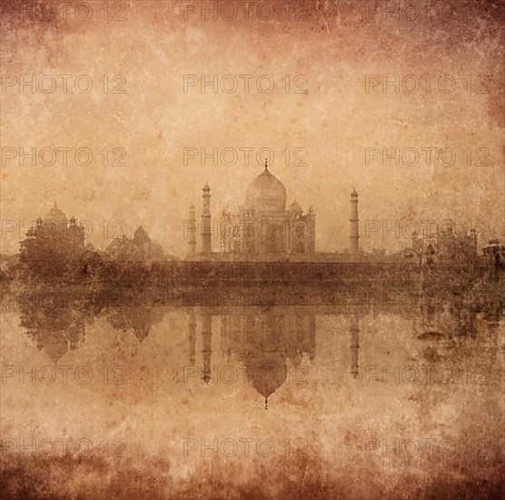 Vintage retro hipster style image of Taj Mahal with reflection in Yamuna river panorama in fog