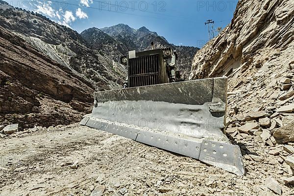 Bulldozer doing mountain road construction in Himalayas. Himachal Pradesh