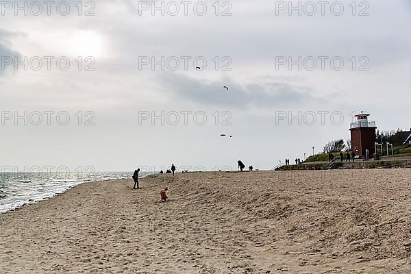 Strollers on the south beach in autumn