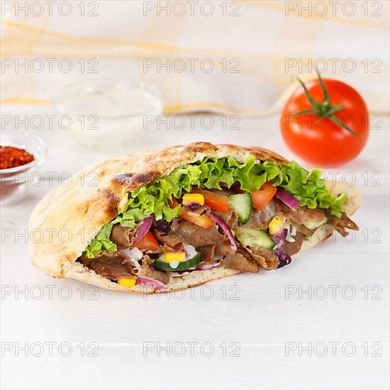 Doener Kebab Doner Kebap fast food meal in pita bread on wooden board square in Stuttgart