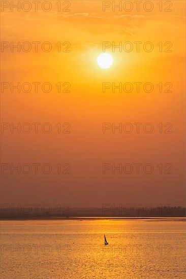 Yacht boats silhouettes in lake on sunset