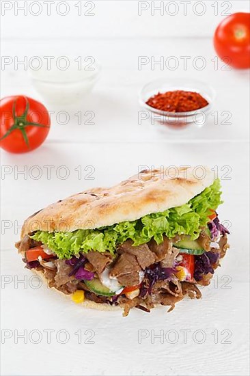 Doener Kebab Doner Kebap fast food meal in pita bread on wooden board in Stuttgart