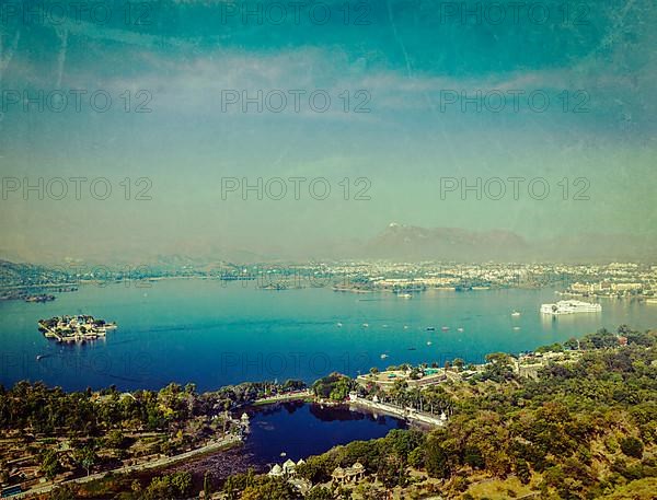 Vintage retro hipster style travel image of aerial view of Lake Pichola with Lake Palace