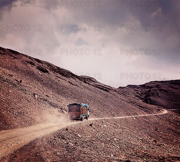 Vintage retro effect filtered hipster style travel image of Manali-Leh Road in Indian Himalayas with lorry. Himachal Pradesh