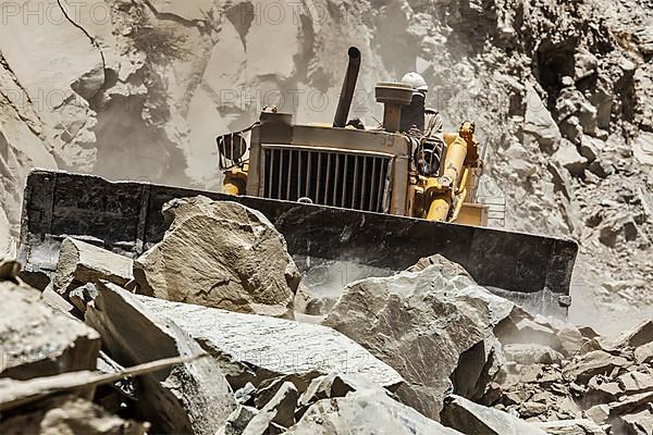 Bulldozer doing mountain road construction in Himalayas. Himachal Pradesh