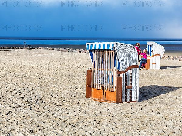 Locked beach chair on an empty sandy beach