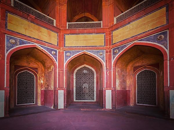 Vintage retro effect filtered hipster style travel image of arch with carved marble window. Mughal style. Humayun's tomb