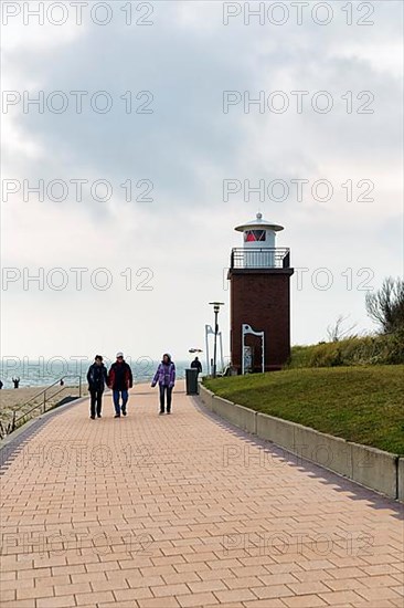 Pedestrians on the beach promenade in autumn