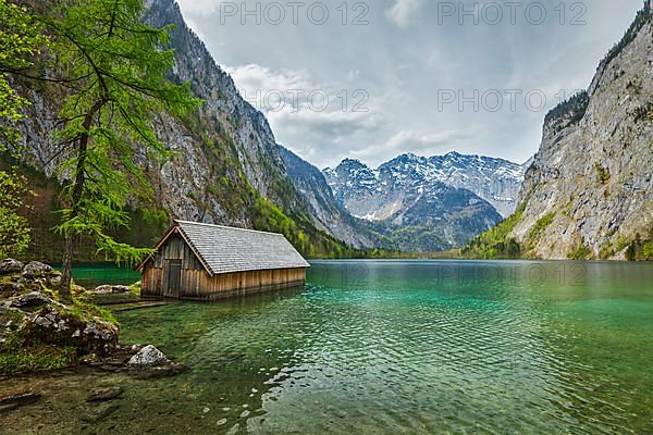 Boat dock hangar on Obersee mountain lake in Alps. Bavaria