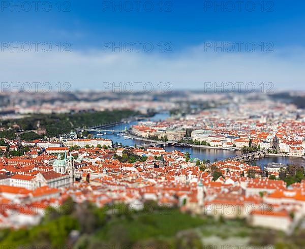 Aerial view of Charles Bridge over Vltava river and Old city from Petrin hill Observation Tower with tilt shift toy effect shallow depth of field. Prague