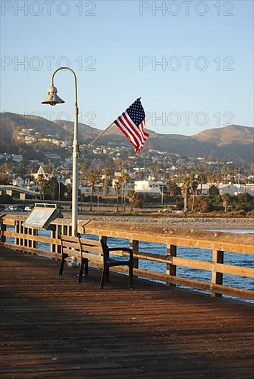 American flag waving on a pole in Ventura Pier