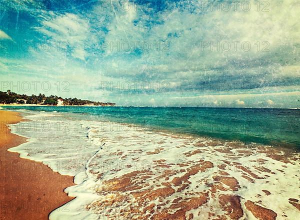 Vintage retro hipster style travel image of tropical paradise idyllic beach with grunge texture overlaid. Sri Lanka
