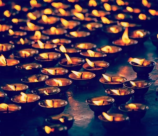 Vintage retro effect filtered hipster style travel image of burning candles in Buddhist temple. Tsuglagkhang complex