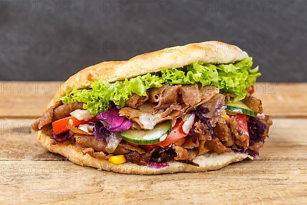 Doener Kebab Doner Kebap fast food meal in pita bread on wooden board in Stuttgart