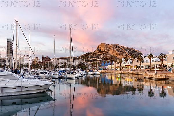 Port of Alicante in the evening Port dAlacant Marina with boats and view of Castillo Castle Holiday travel city in Alicante