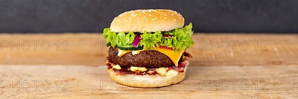 Hamburger Cheeseburger Fast Food Food on Wooden Board Panorama with Text Free Space in Stuttgart