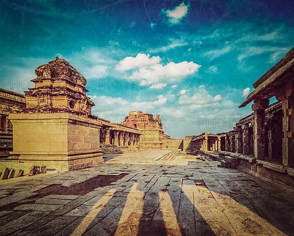 Vintage retro hipster style travel image of Krishna temple on sunset with grunge texture overlaid. Royal Center