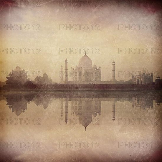 Vintage retro hipster style image of Taj Mahal on sunrise sunset reflection in Yamuna river panorama in fog