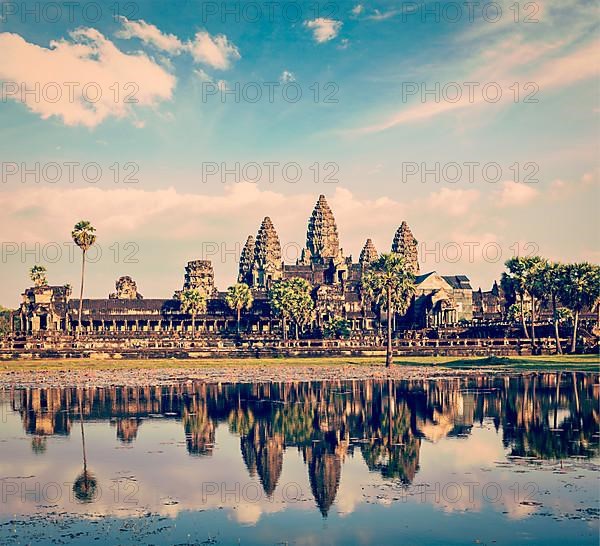 Vintage retro effect filtered hipster style travel image of Cambodia landmark Angkor Wat with reflection in water