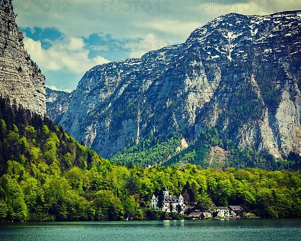 Vintage retro effect filtered hipster style travel image of castle at Hallstatter See mountain lake in Austria. Salzkammergut region