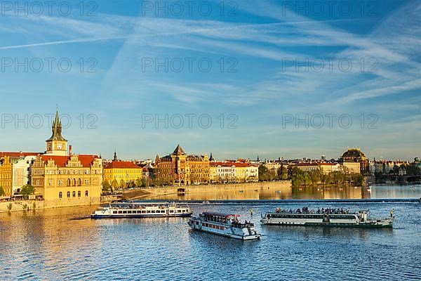 Vltava river with tourist boats and Prague Stare Mesto embankment view from Charles bridge on sunset. Prague